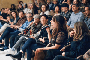 Frances Forbes-Carbines speaking from the audience during Q&A at Radical Software: Women, Art & Computing 1960–1991 exhibition event, MUDAM Luxembourg – discussing pioneering women in digital art and technology

